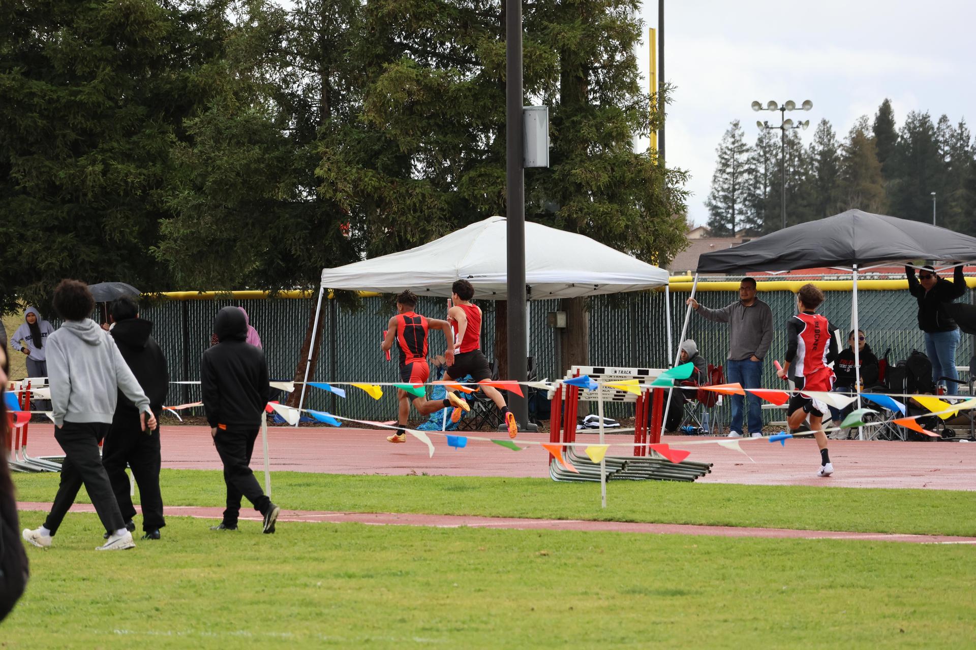 junior varsity boys running the four by 100 meter relay