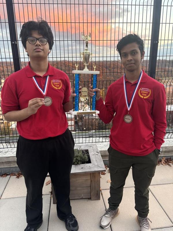 Students holding a trophy.