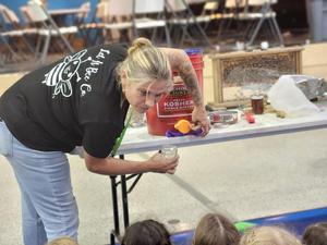 Beekeeper Melissa shows how she stores the honey she extracted.