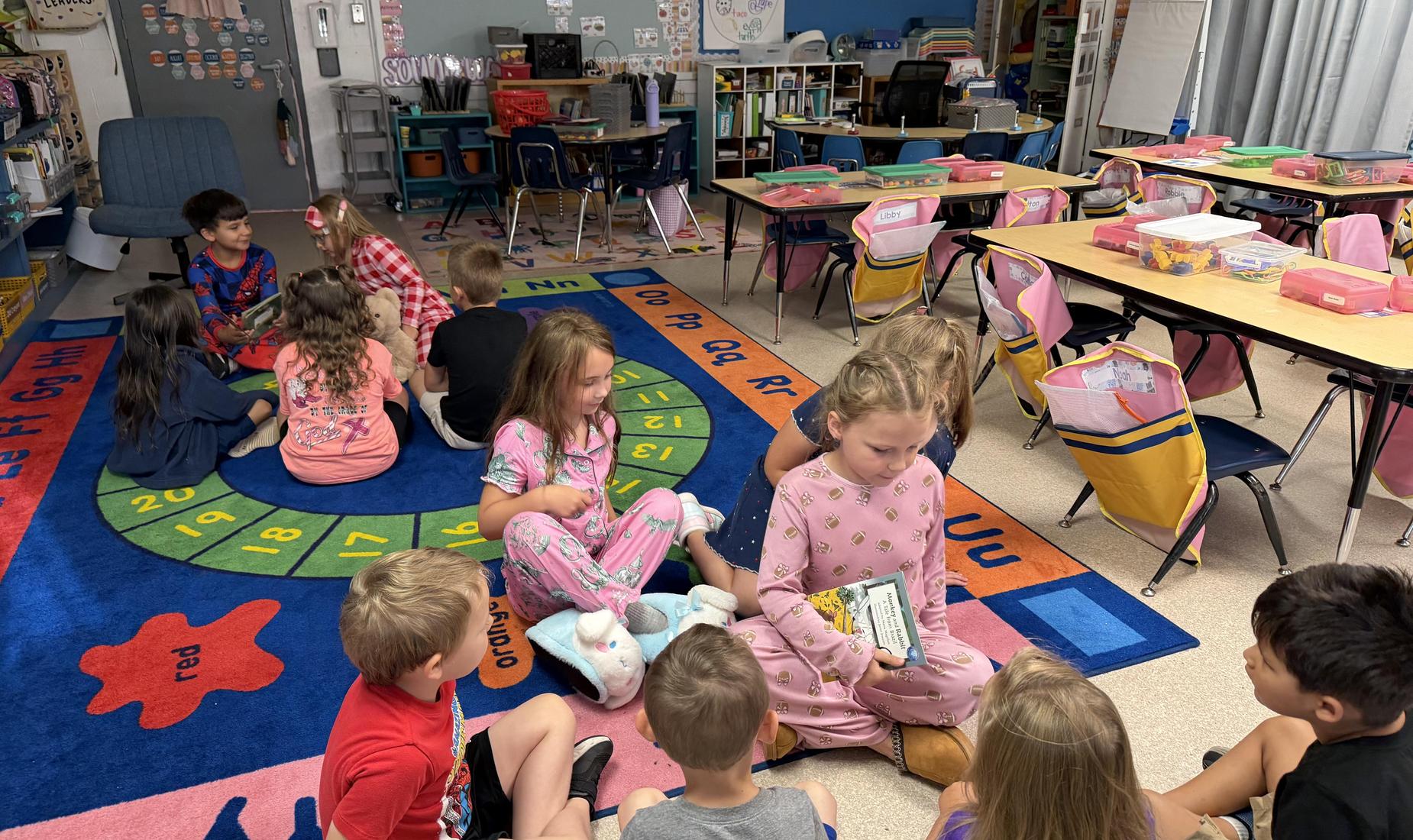 2nd grade students reading to Kindergarten students