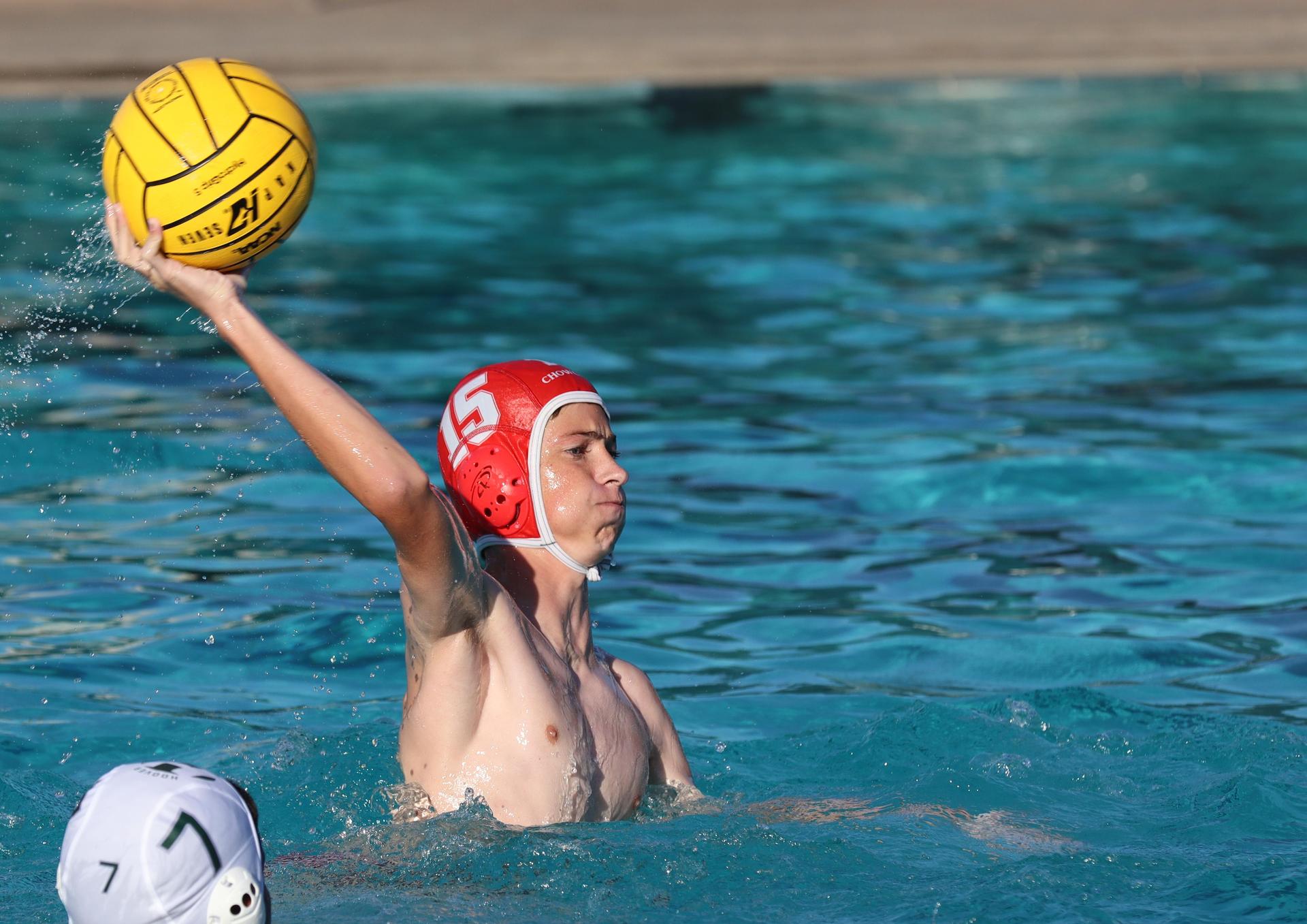 boys water polo players in action against hoover