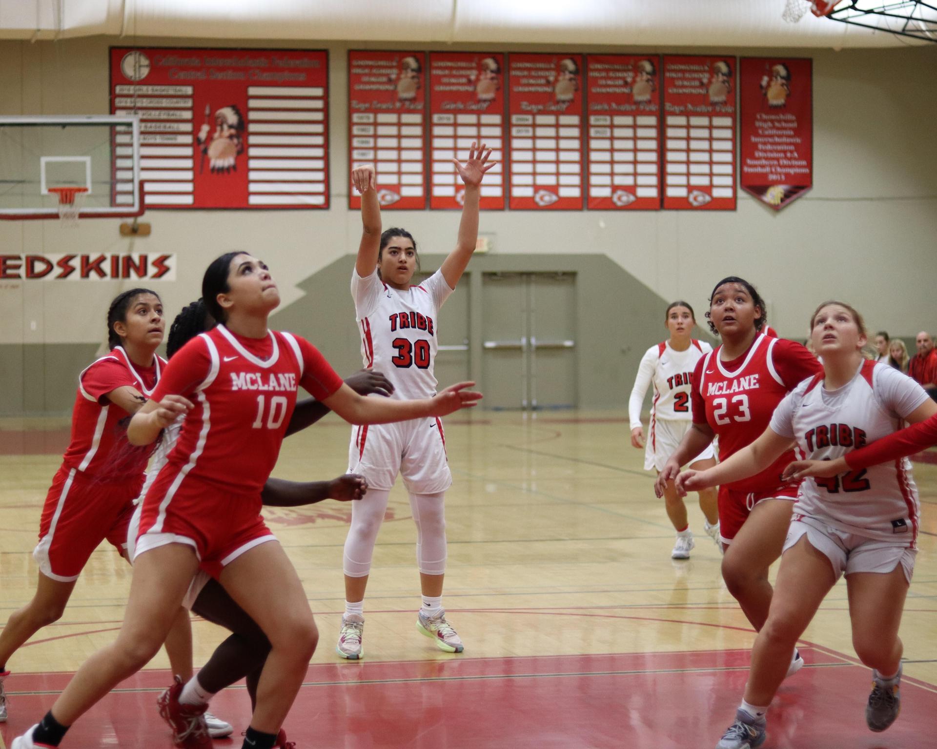 varsity girls playing basketball against mclane