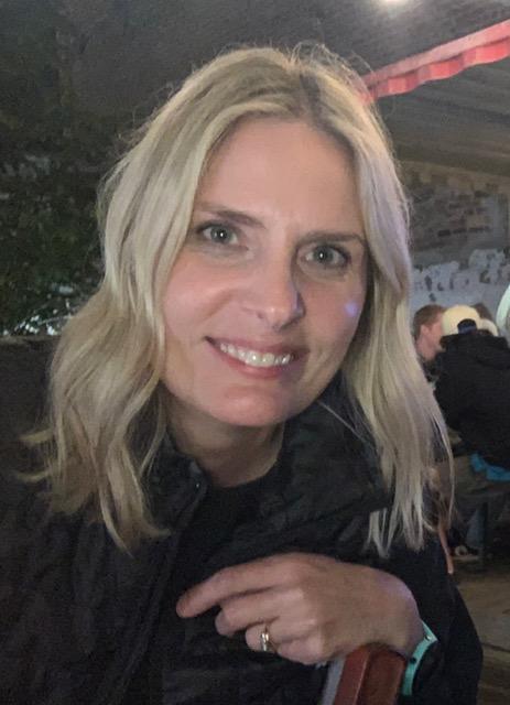 Art teacher with blond hair and black jacket