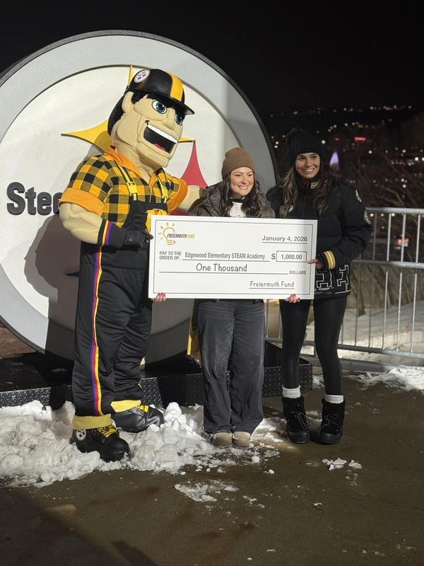 Ms. Pearsick with the Steelers mascot and a novelty check