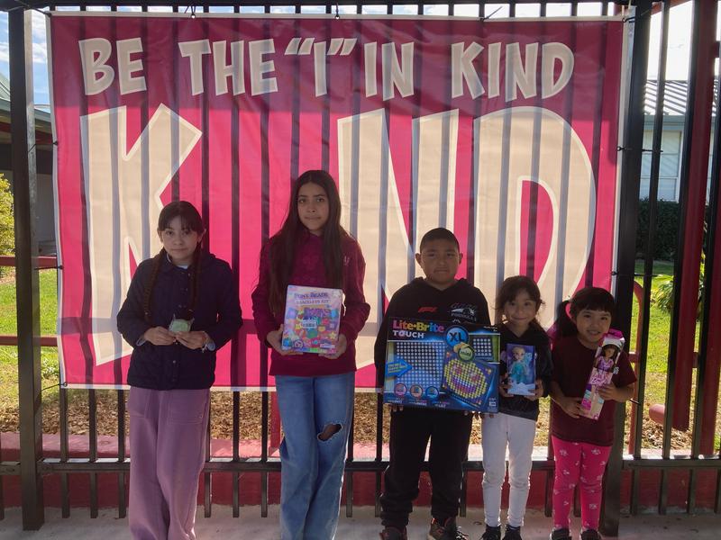 Students holding a toy