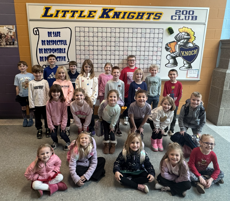 group of students standing in front of 4 B's Board