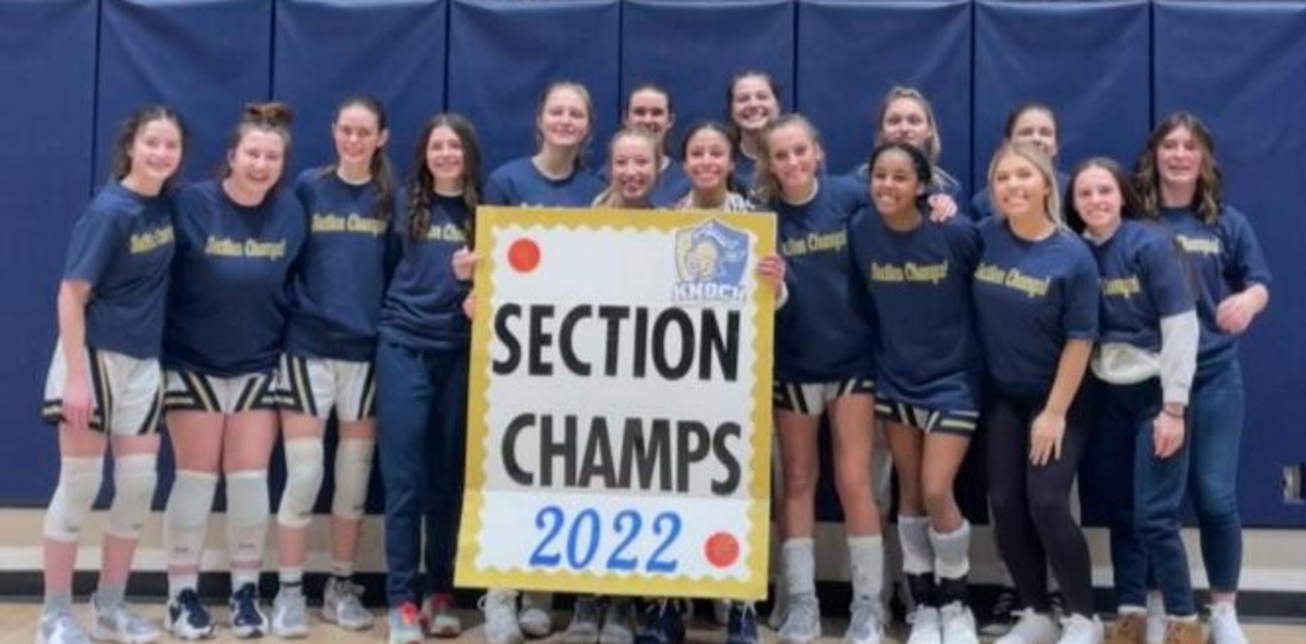 girls' basketball team with section champs sign