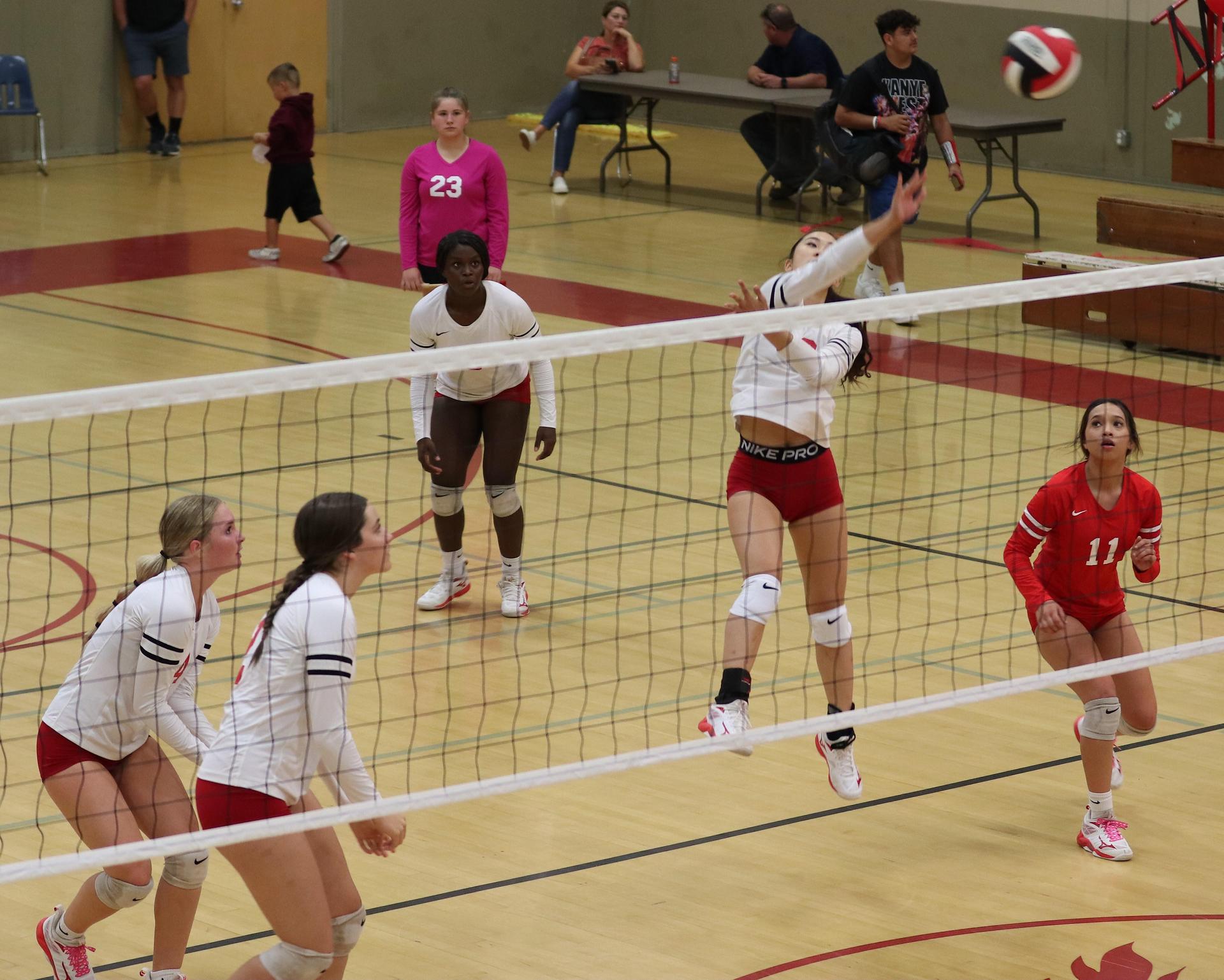 varsity volleyball players in action against Minarets
