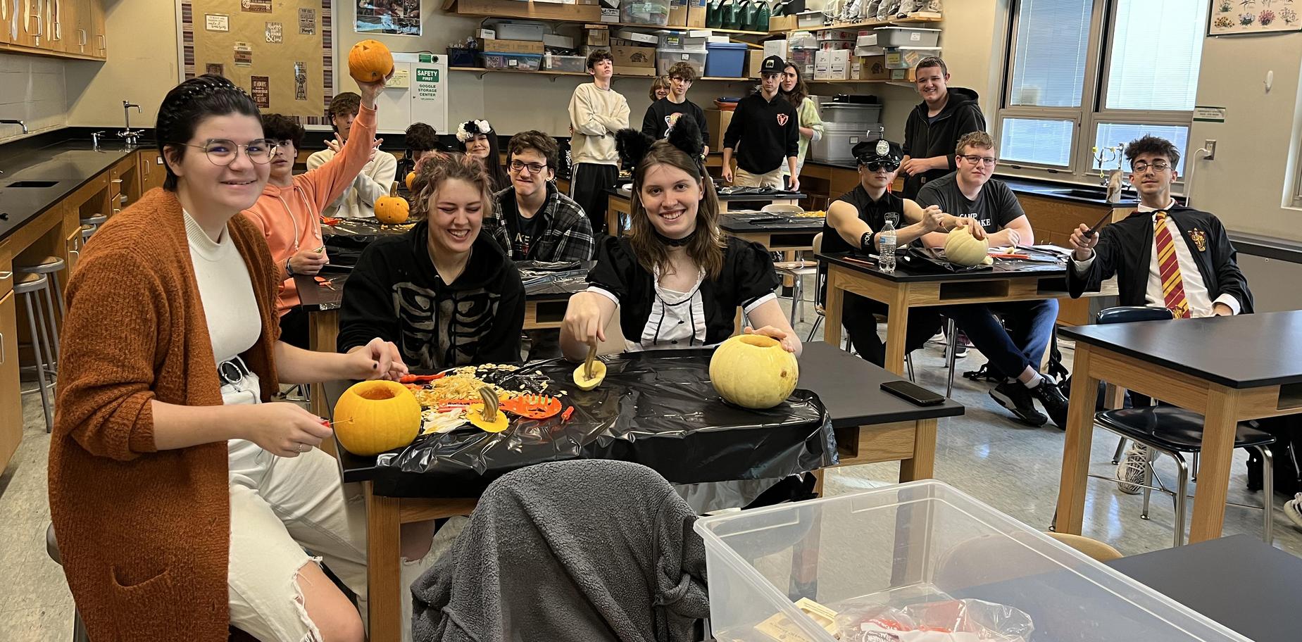 kids in costumes carving pumpkins