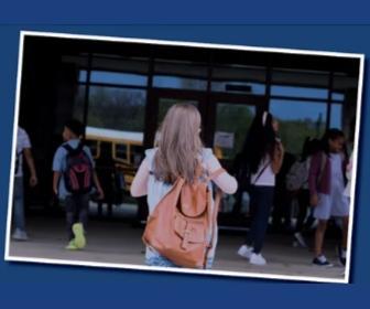 students walking into school building