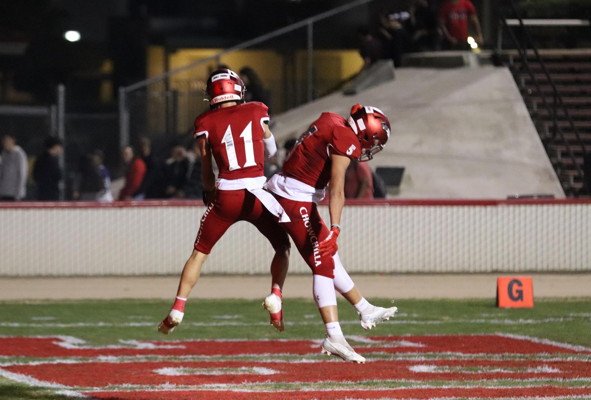 varsity football players in action against Riverdale
