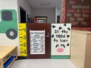 A classroom door with a height chart and a sign that says "In the MOOD to learn"