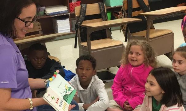 Mrs. Monique Smith sharing One Fish Two Fish Red Fish Blue Fish with her class in Jamaican Patois Style for International Literacy Day.