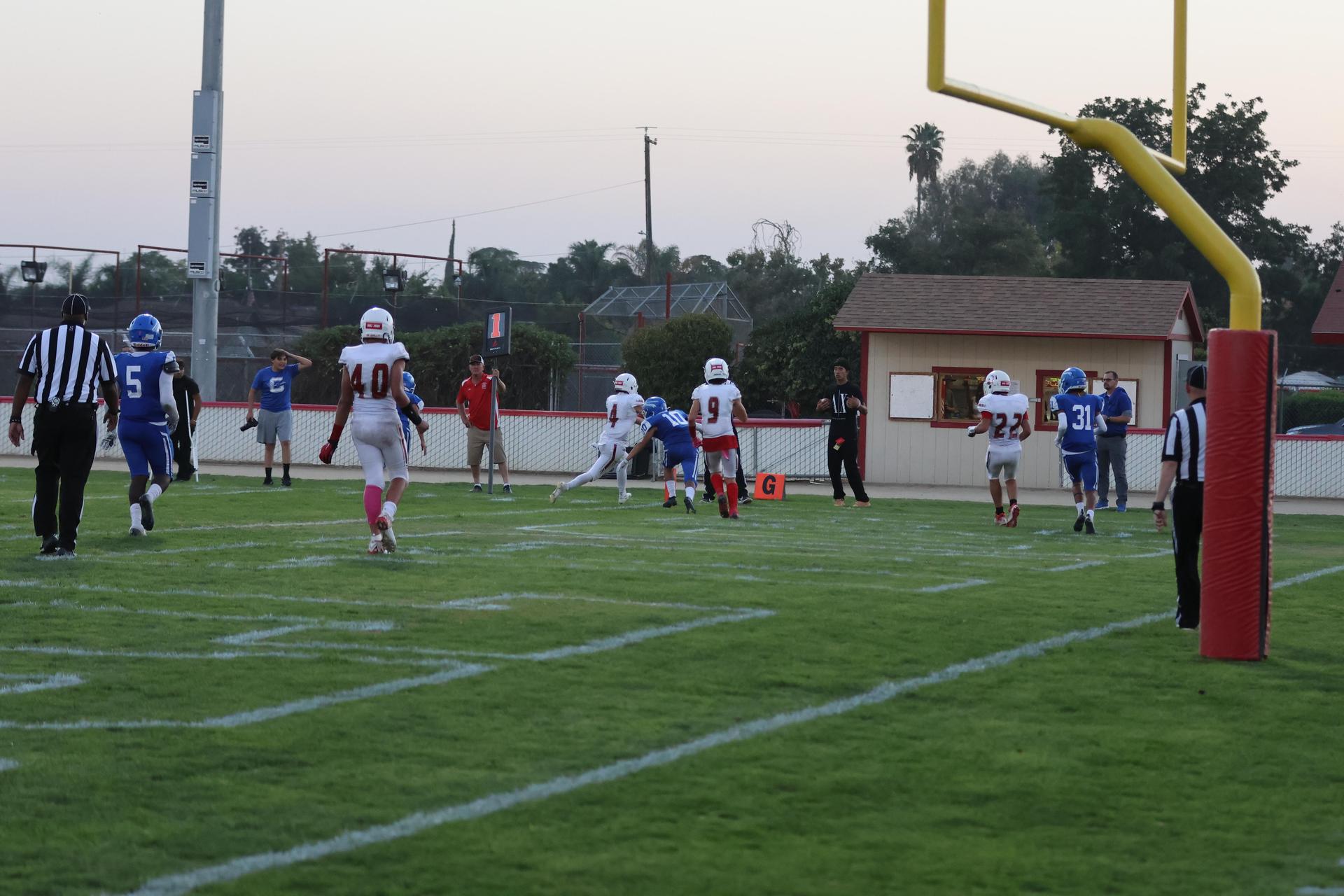 Junior Varsity football players in action against Caruthers