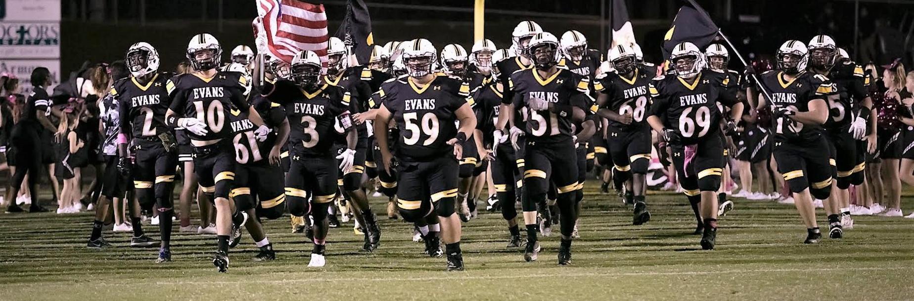 Football team running on the field
