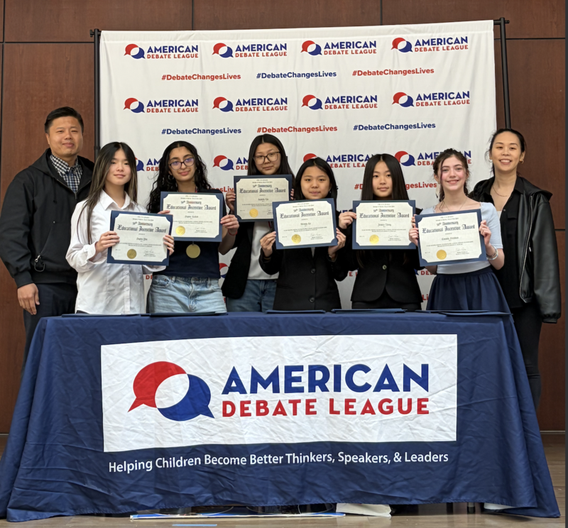 girls on the debate team holding their certificates from the award ceremony