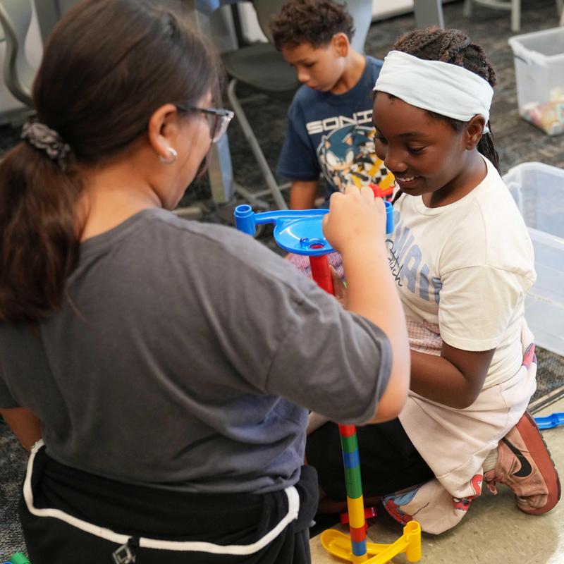 students create a marble run in a classroom