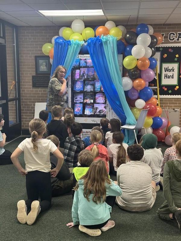 Students are excited as the new book vending machine is revealed.