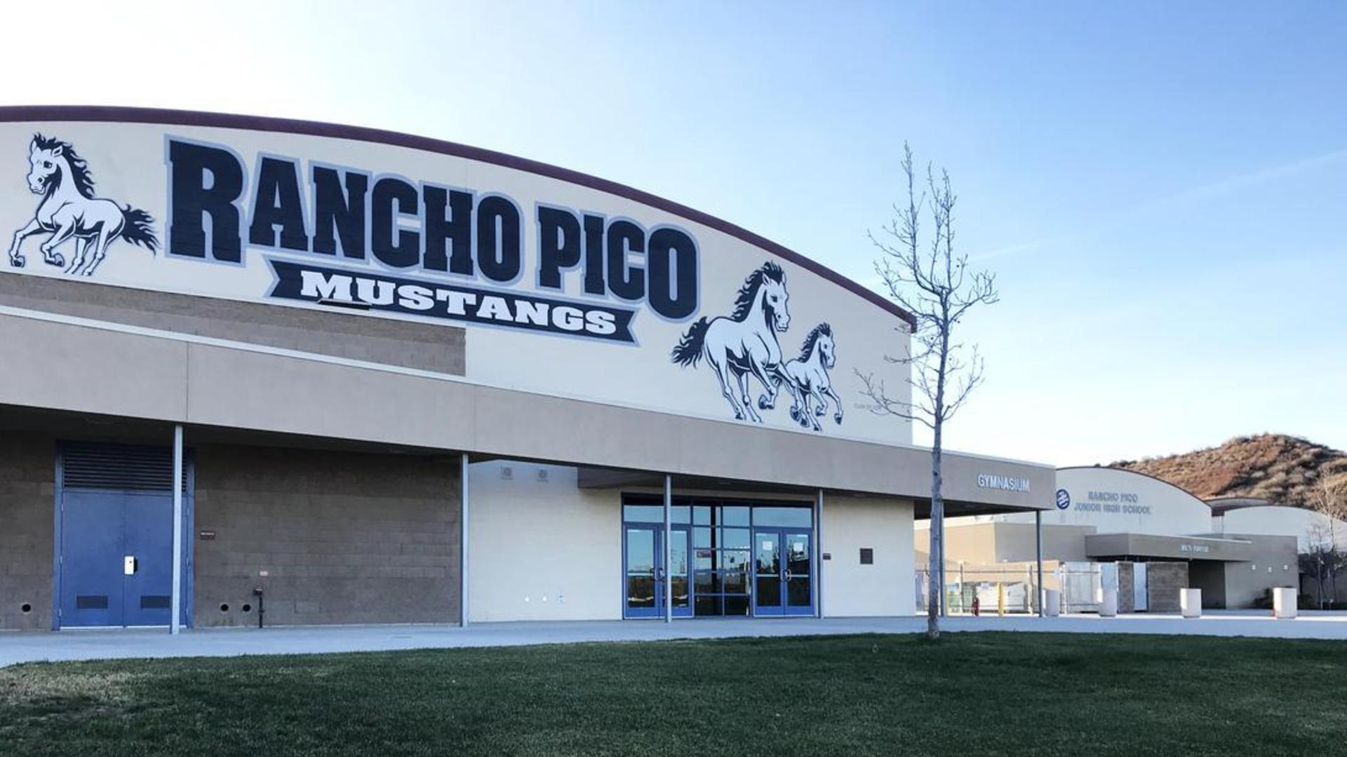 Gymnasium exterior from the front that displays the Rancho Pico Mustangs mural.