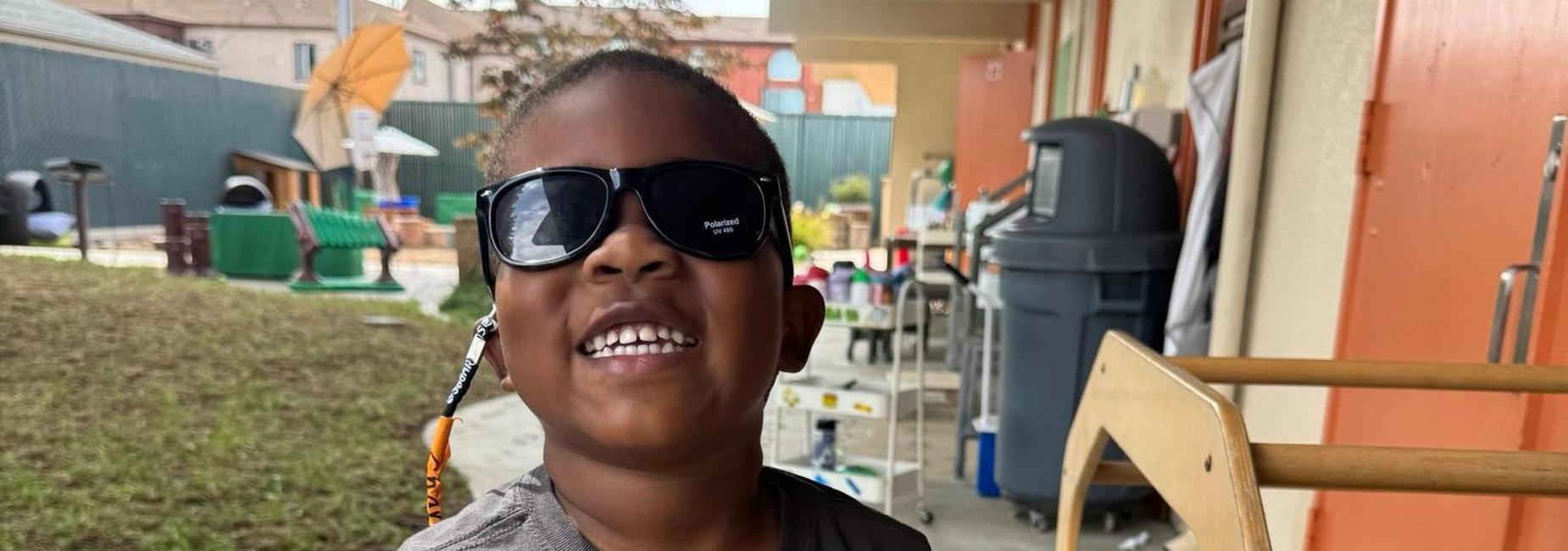 Child smiling with sunglasses