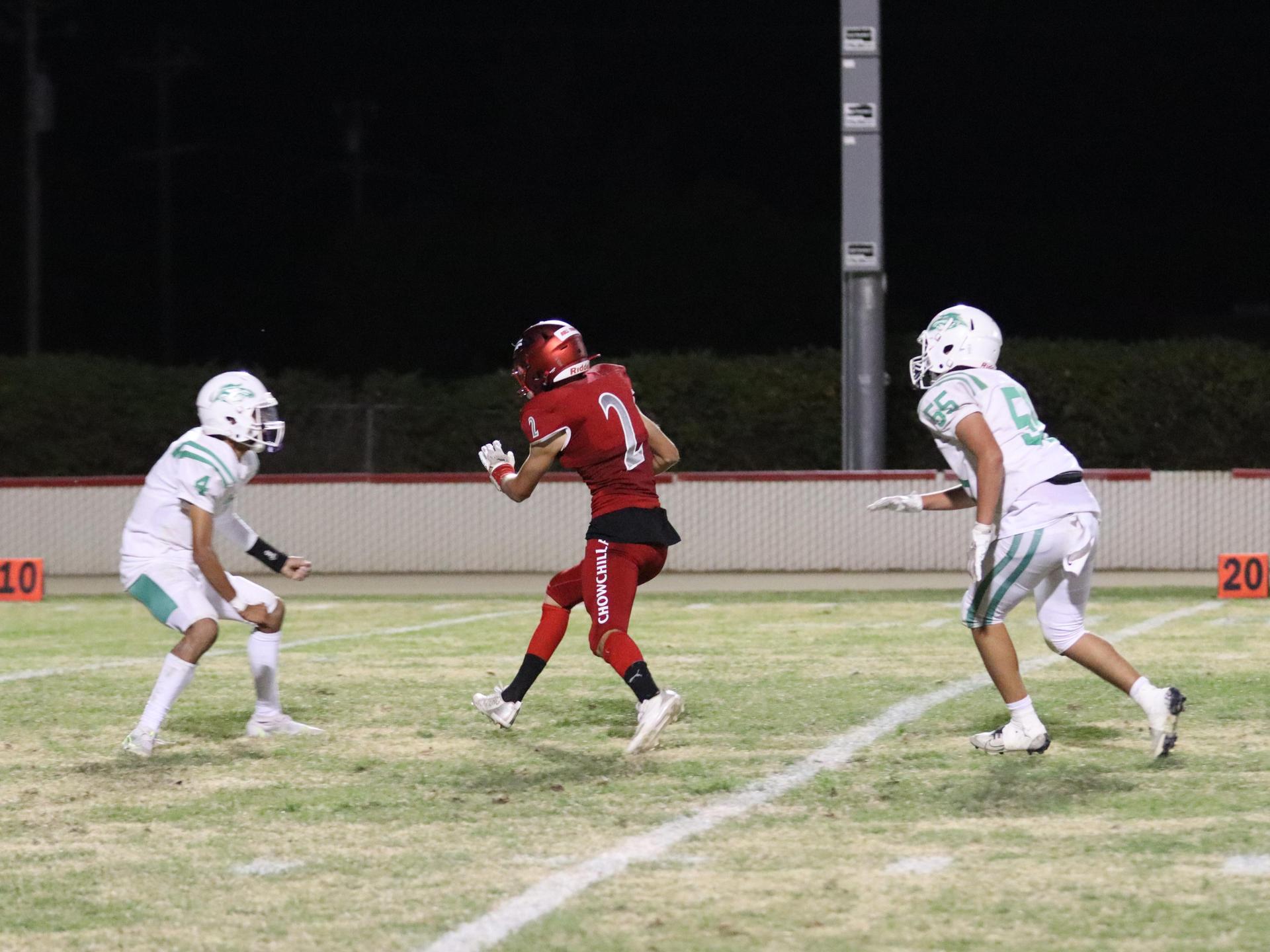 varsity football players in action against Riverdale