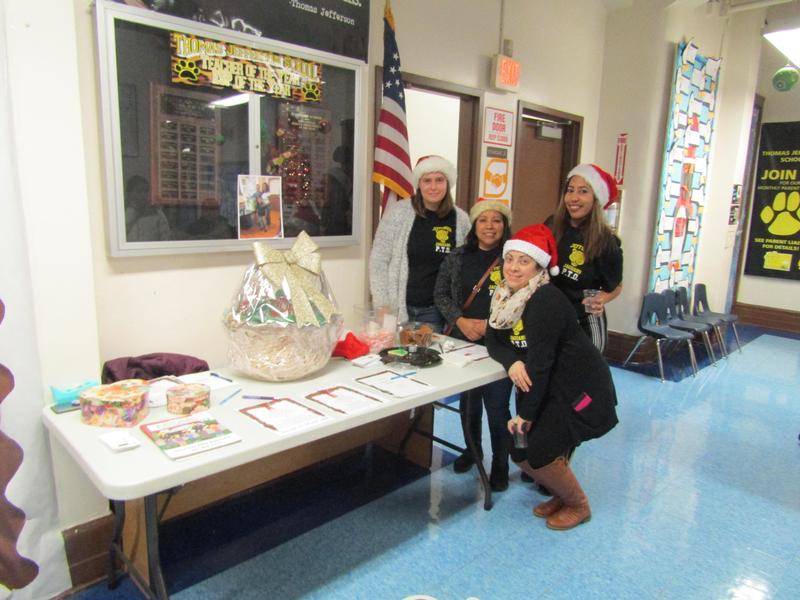 teachers aide dressed as santas helper at the raffle table