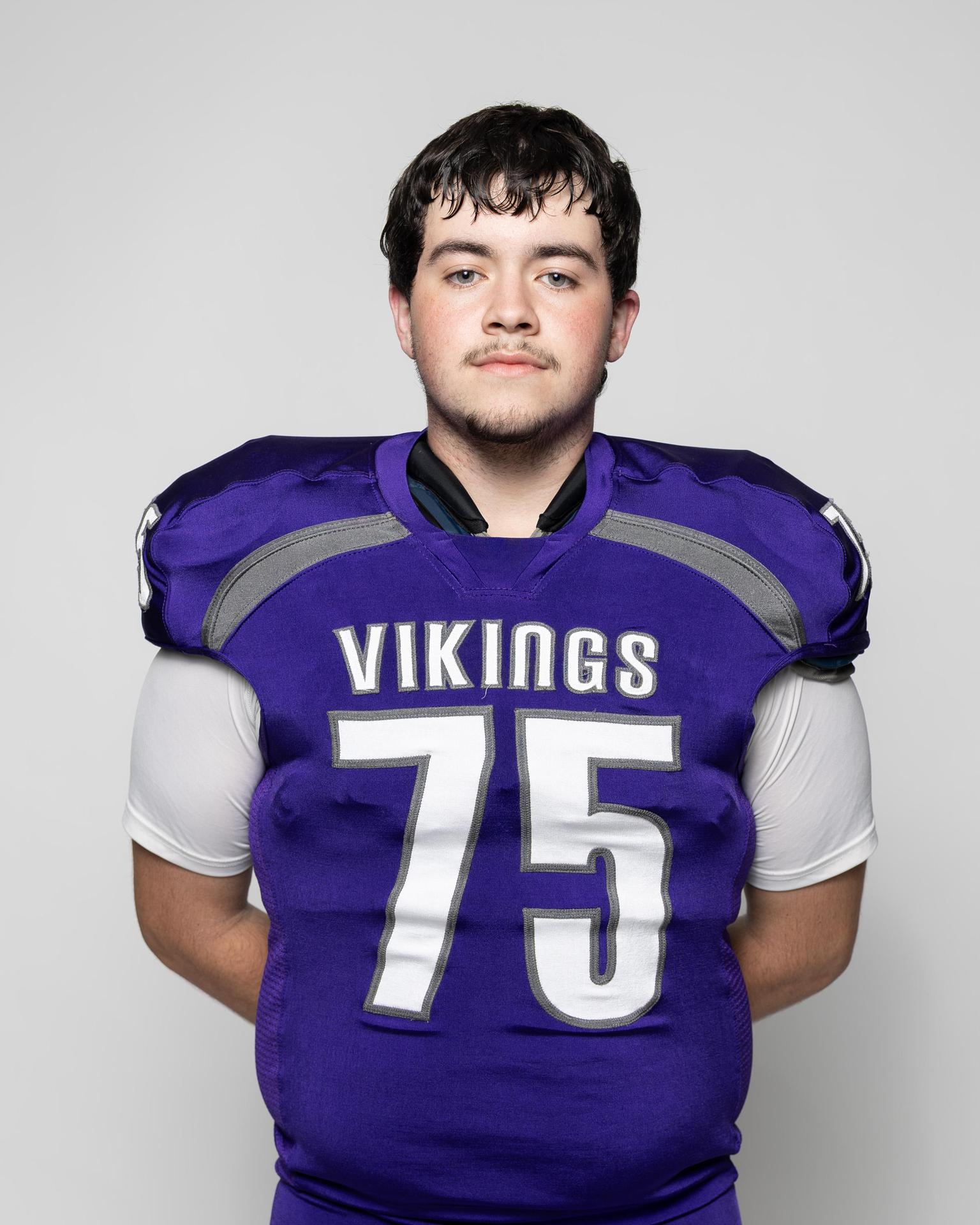 Athlete in a purple football uniform with the number 75.
