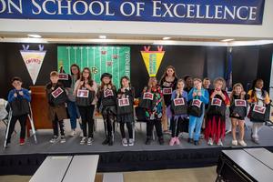 L.L. Beazley Elementary School students and their teacher, Mrs. Schwalm, hold some of the “dinner-in-a-bag” meal kits the school packed to help families facing furloughs during the ongoing government shutdown. (PGCPS Photo)