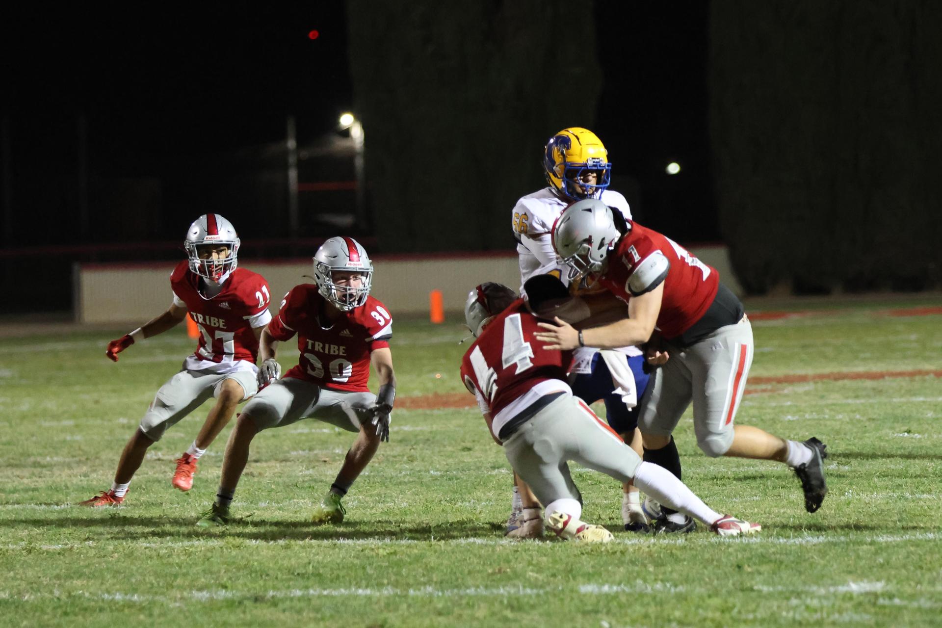 Varsity football players in action against Parlier 101