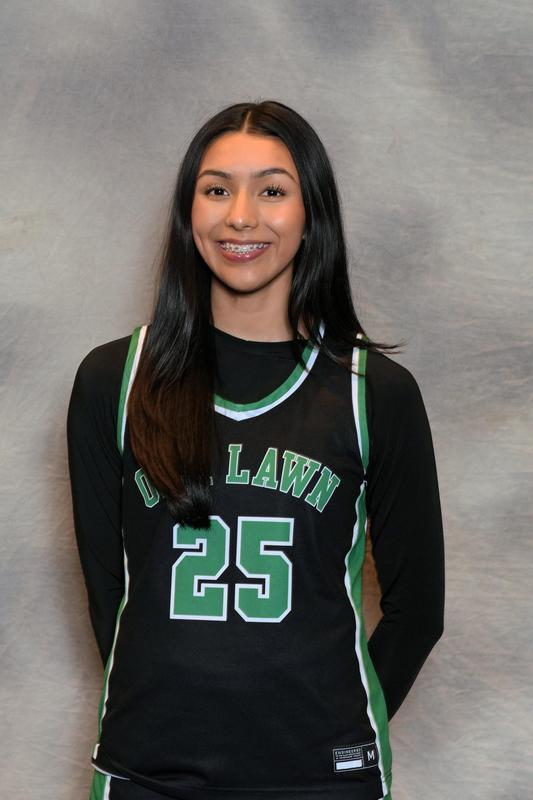 A young woman in a green and black basketball uniform with the number 25.
