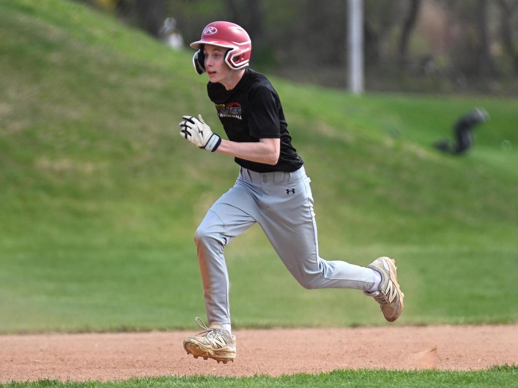 A baseball player wearing a helmet running.