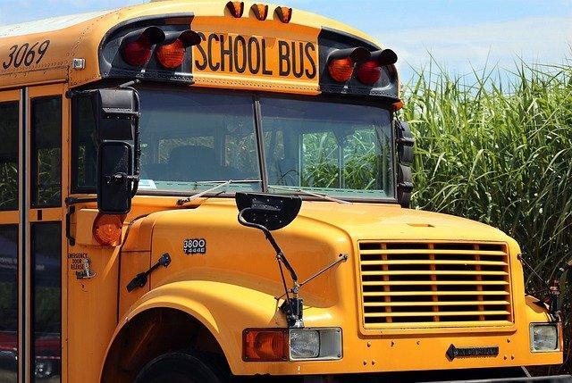 Front passenger side of yellow school bus.