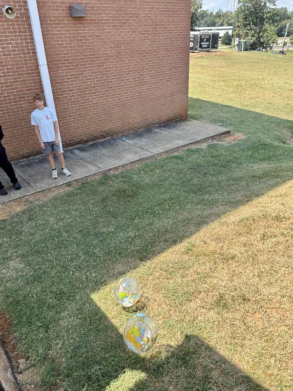 Boy kicks the ball up the hill