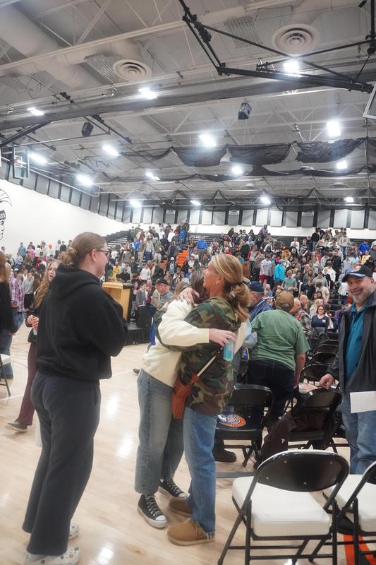 A student gives her mom (a veteran) a hug after the program.