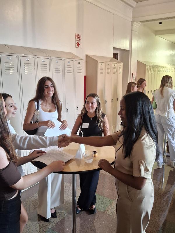 handshake with lauren and students