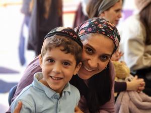 A student poses with his mother.