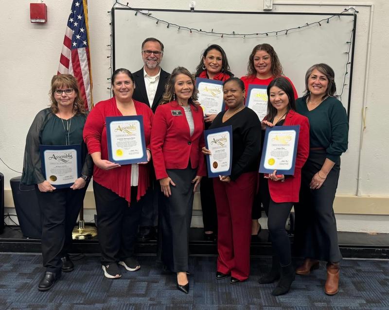 10 educators pose with Assembly Certificates