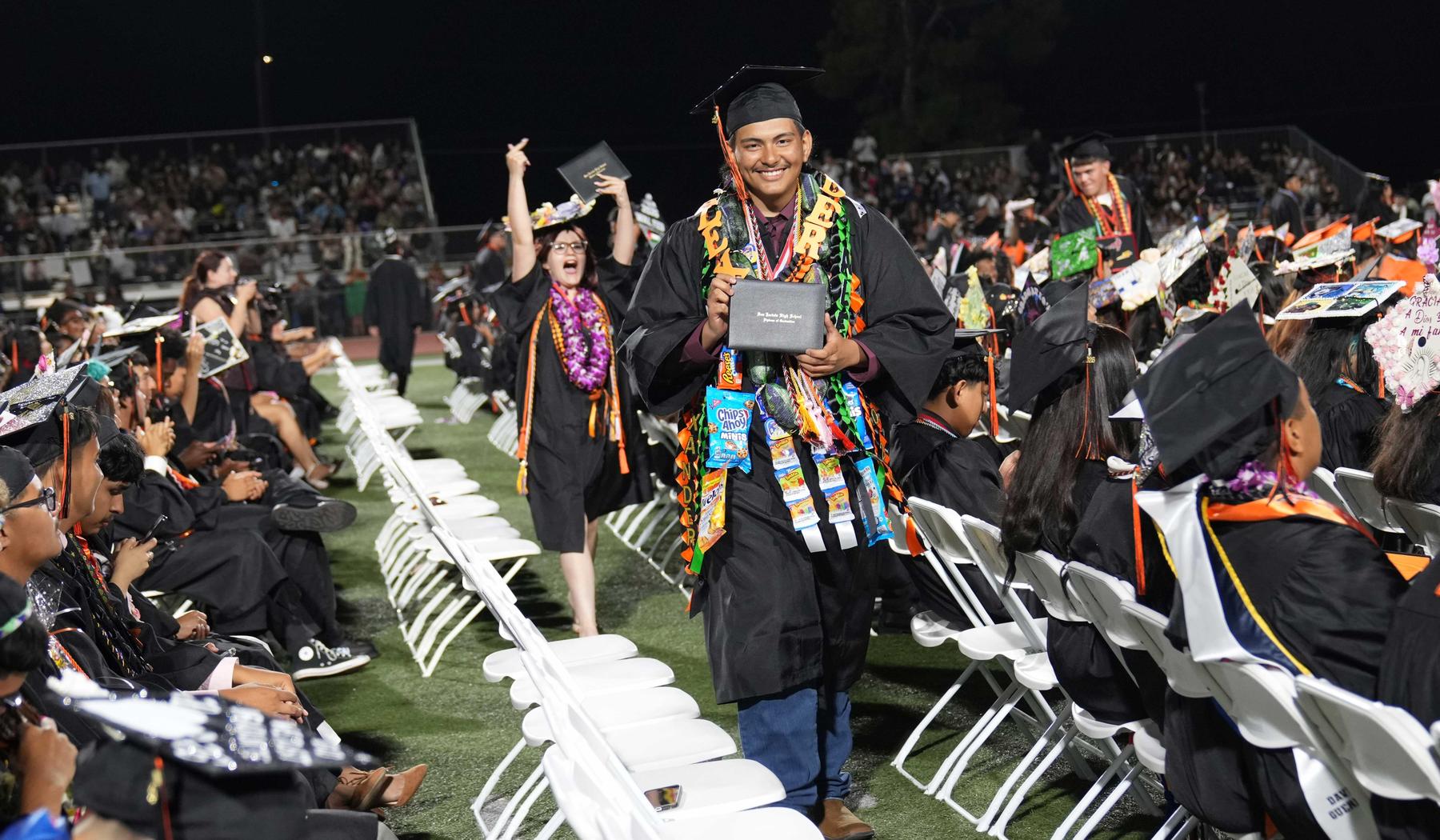 two SJHS grads showing off their diploma