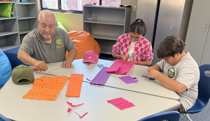 Students working on art projects for dia de los muertos