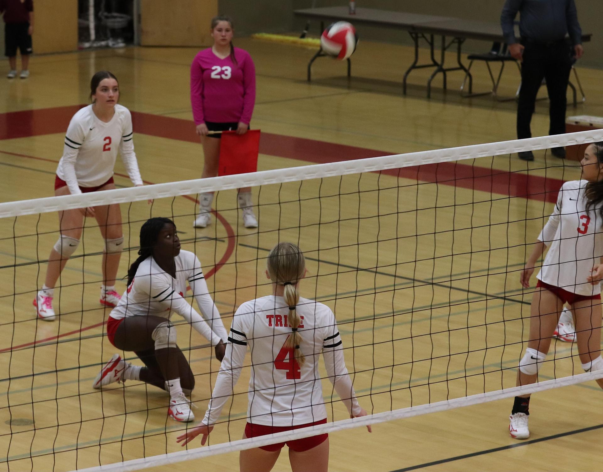 varsity volleyball players in action against Minarets