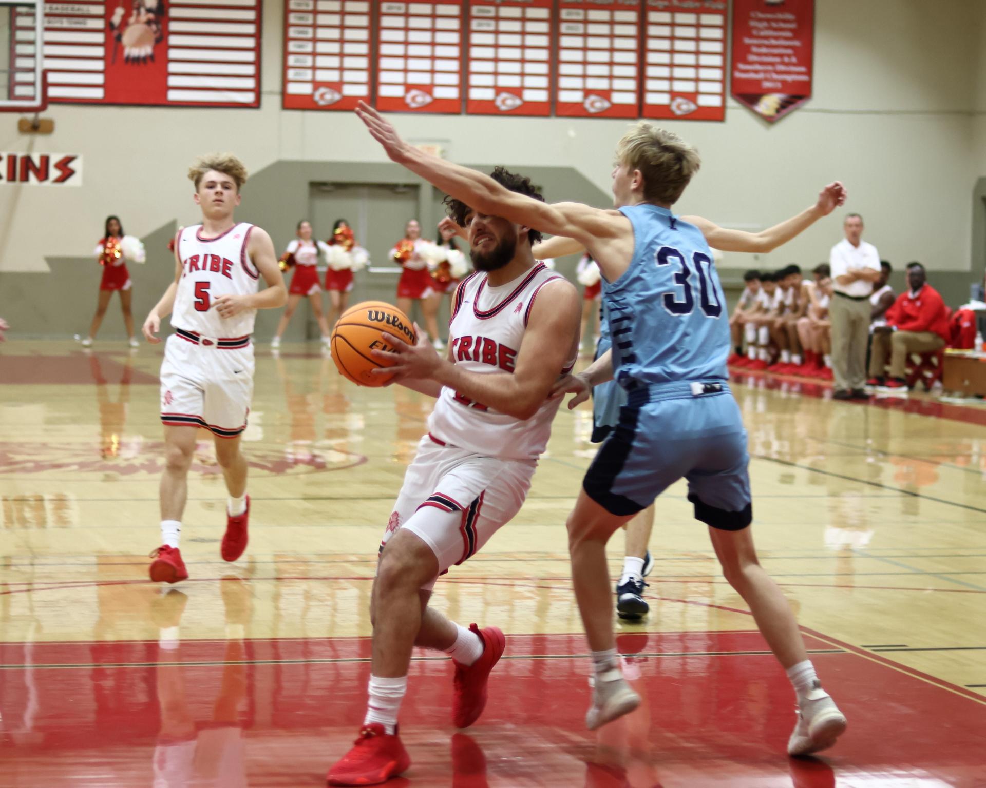 Varsity boys playing basketball against yosemite