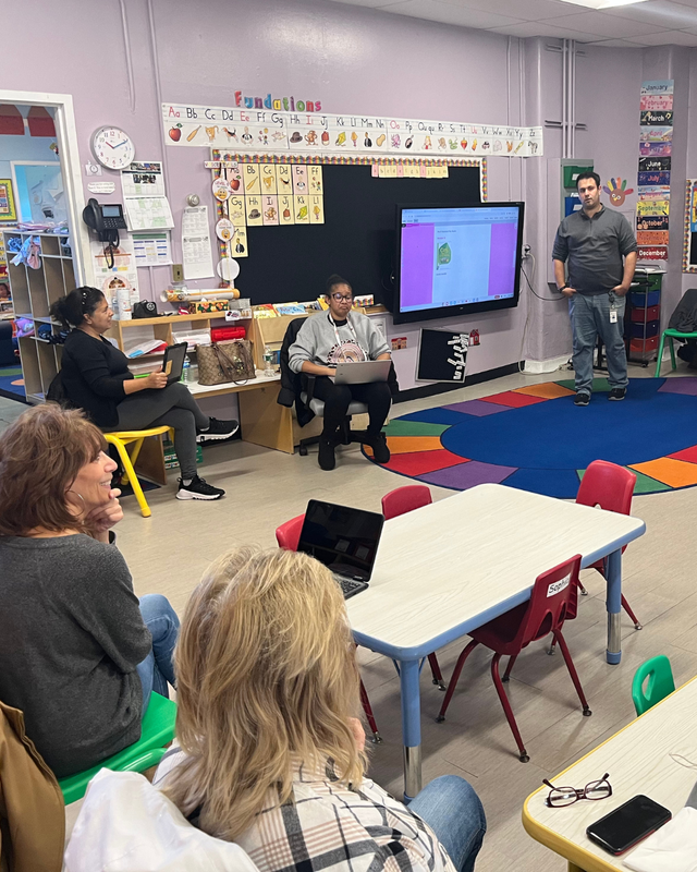 Teachers listen to lesson during conference day
