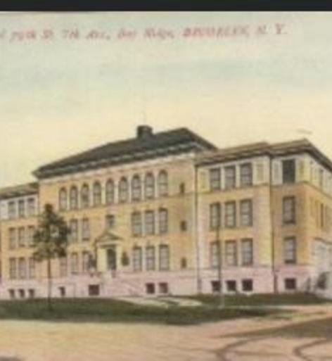 Historic school building in a serene neighborhood setting.