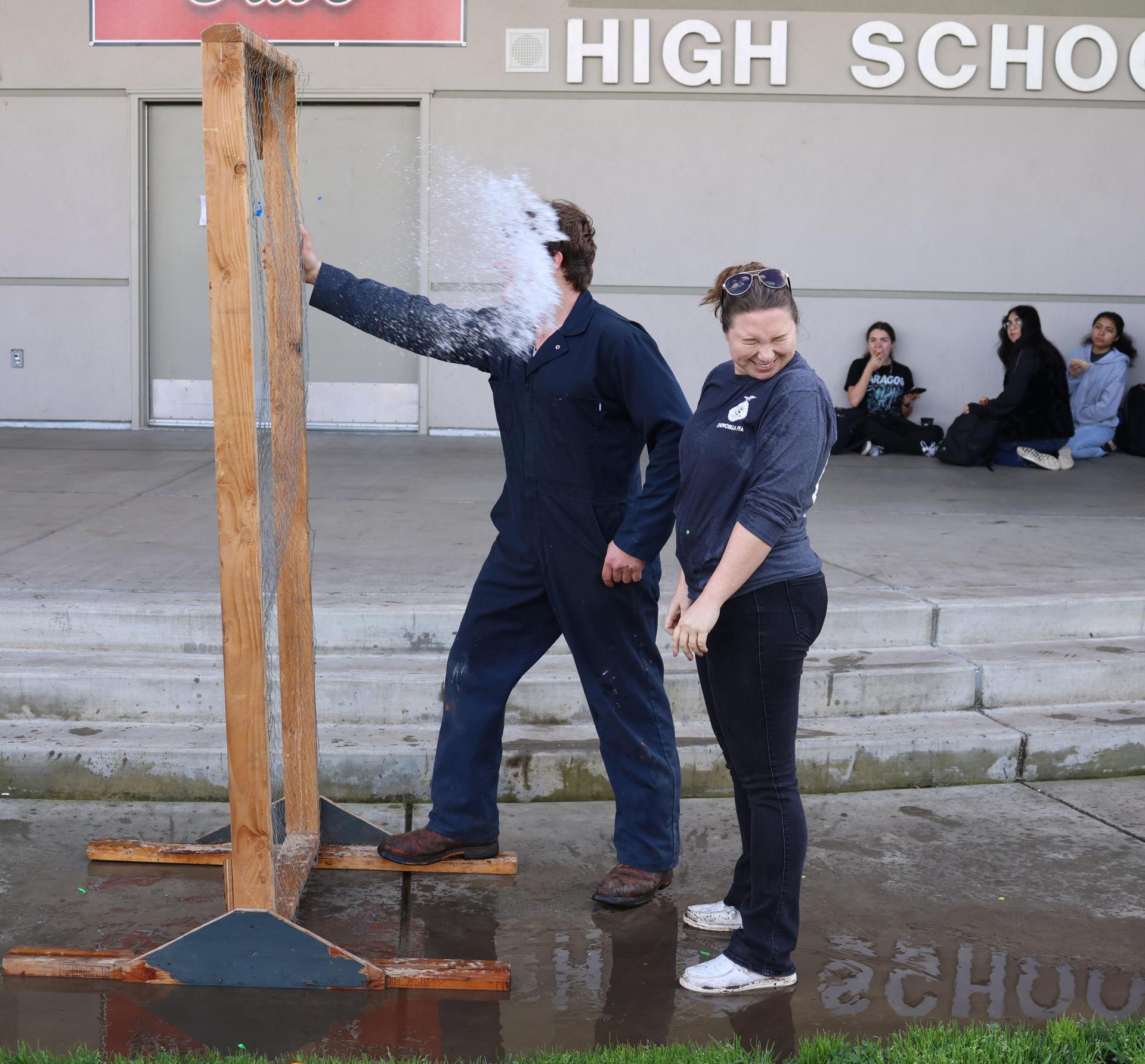 students and staff enjoying the water balloon toss