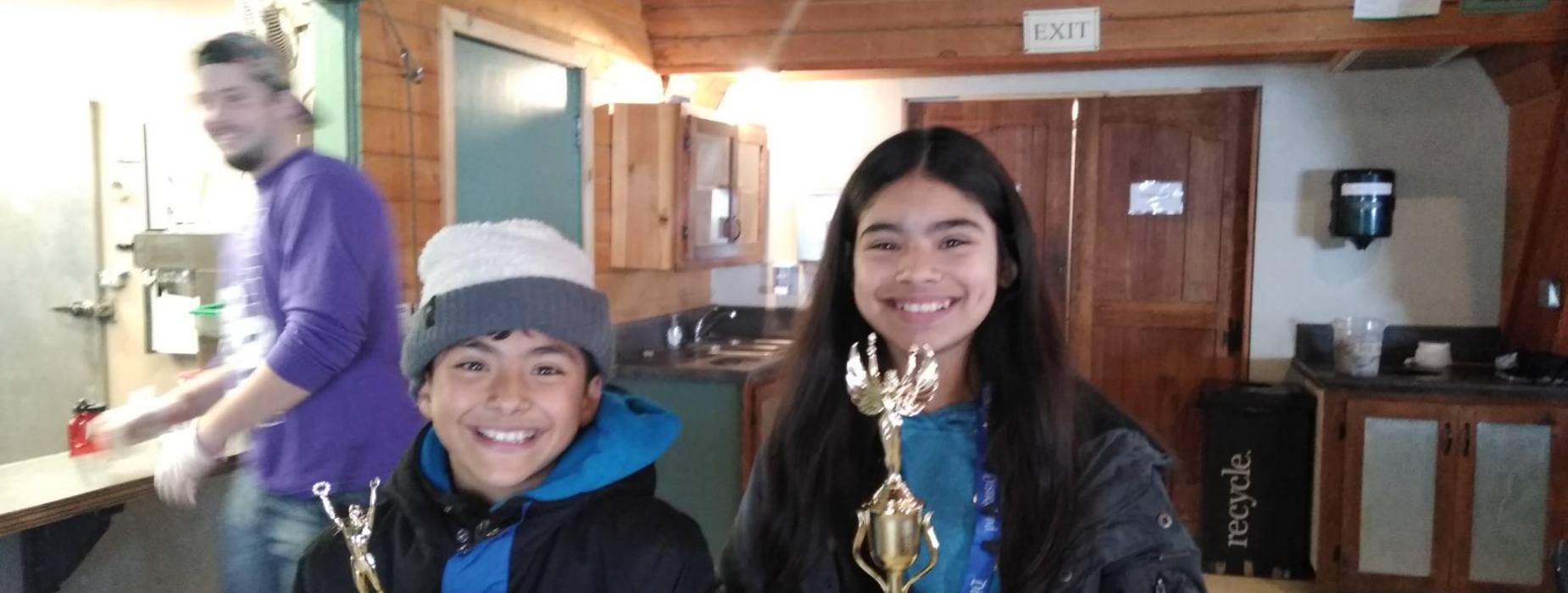 campers of the year holding their trophies