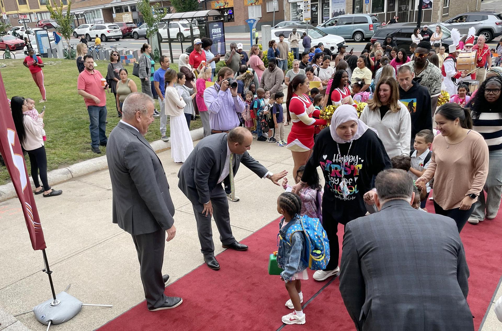 Young students walking into a school building