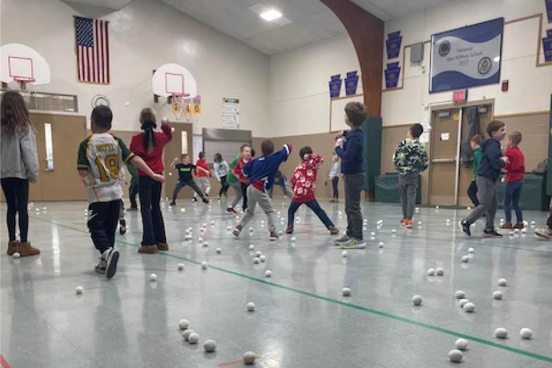 The new speaker sits in the foreground as students enjoy an energetic snowball fight and lively music during gym class at Sunrise Elementary