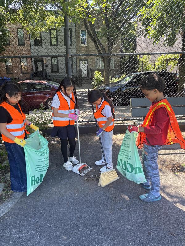 Students working as a team to sweep up trash