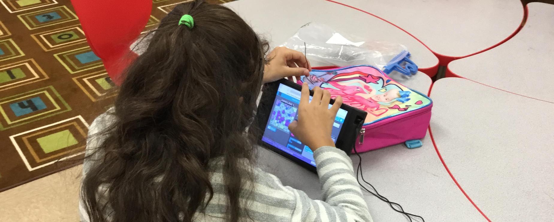 female students coding on the iPad during week of coding