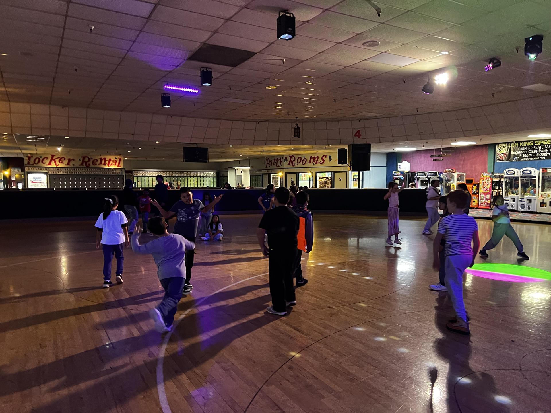 Students in motion at skating rink 